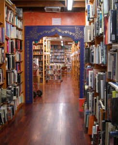 The main aisle between rooms at the Iliad Bookshop